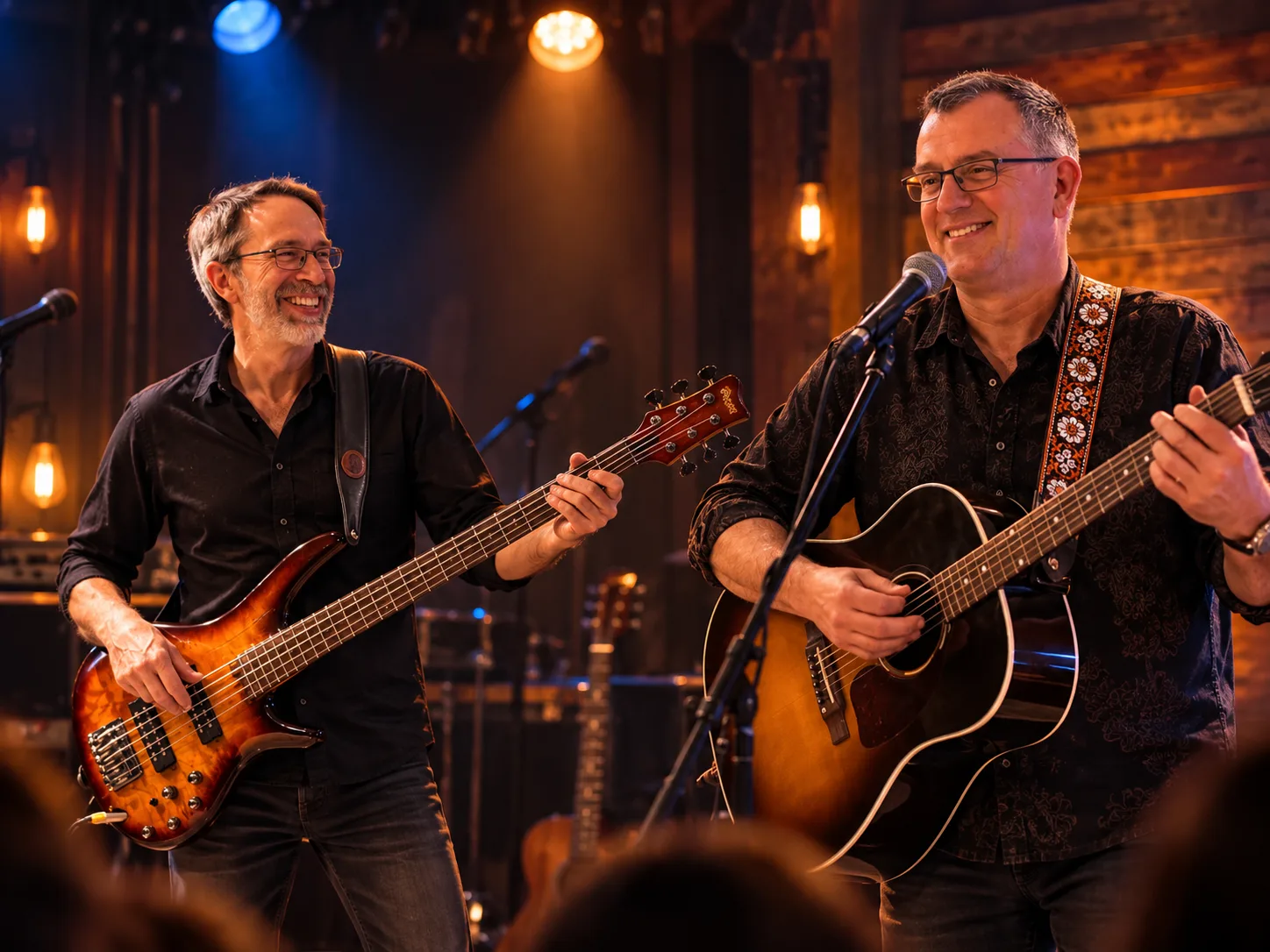 James Wallace on acoustic guitar and vocals with Joe on bass, performing together on an intimate stage.
